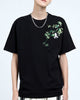 Man in the black embroidered T-shirt, showing the bamboo sprig and panda across the left chest and shoulder