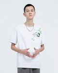 Man in the white embroidered T-shirt, showing the bamboo sprig and panda on the left chest
