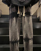 Straight wide-leg tie-dye jeans with dark bands across the thigh and knee, front view