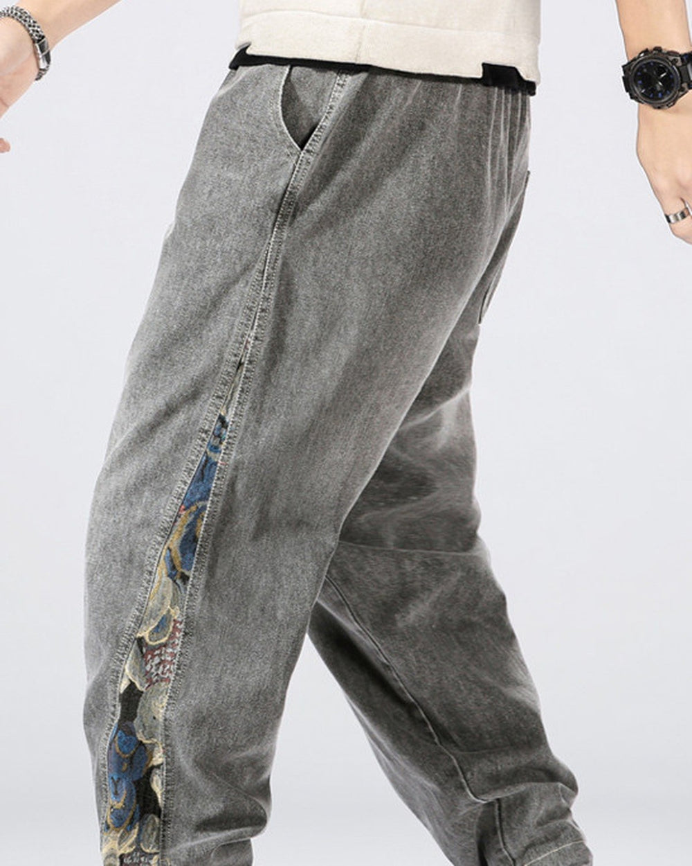 Man walking in the washed gray denim joggers, with the bear panel running down the side seam to the cuff