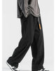 Black corduroy wide-leg pants in motion, showing the wide straight leg