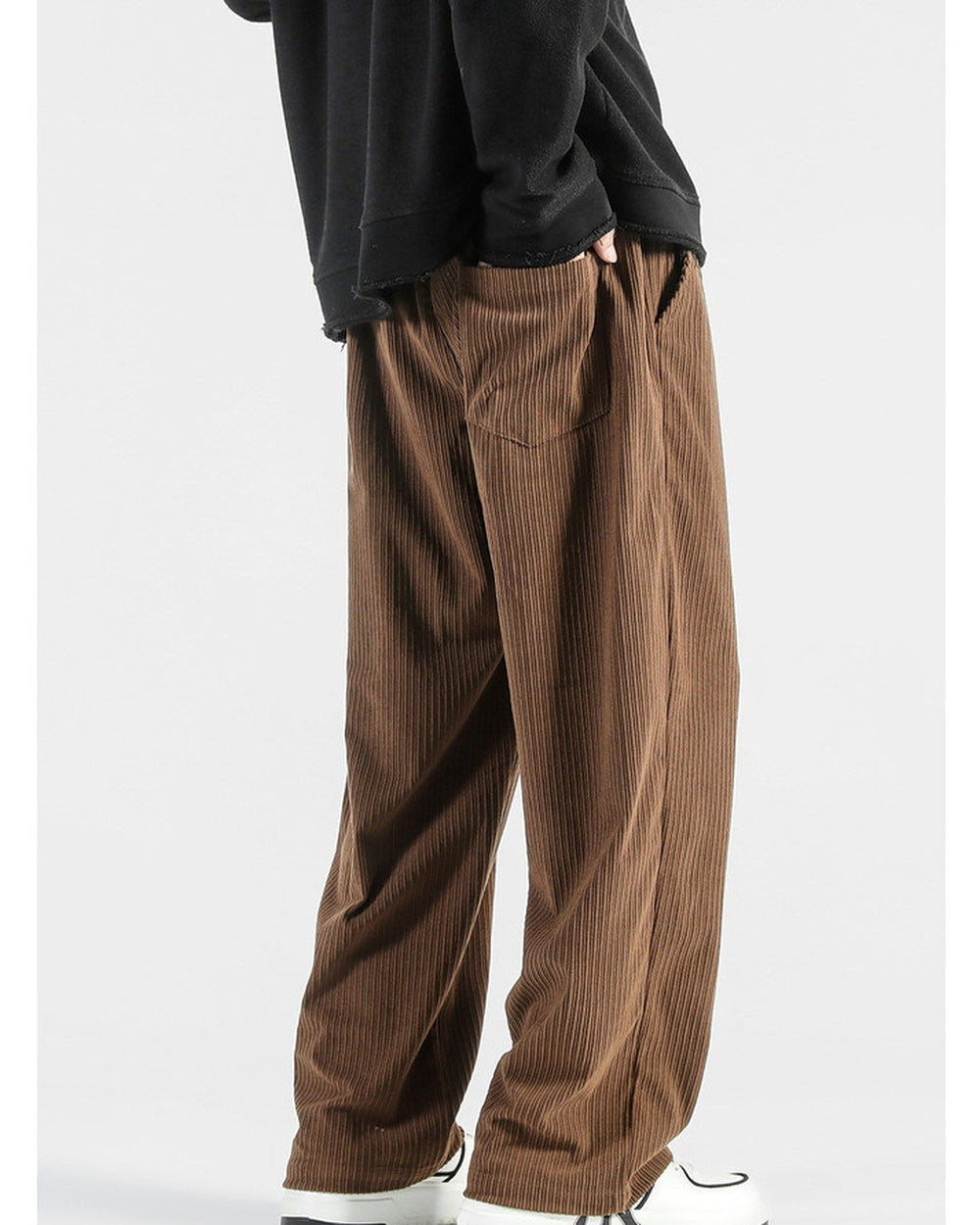 Brown corduroy wide-leg pants, three-quarter view, showing the ribs and the side pocket