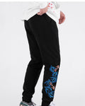 Three-quarter view of the black jogger pants with the koi and wave embroidery