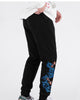 Three-quarter view of the black jogger pants with the koi and wave embroidery