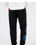 Back view of the black jogger pants with a patch pocket and the embroidery on one leg