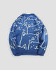Back of the blue cat face knit sweater, with the crowd of white line-drawn cats