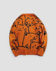 Back of the orange cat face knit sweater, with the crowd of black line-drawn cats