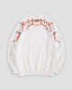 White crew-neck sweatshirt laid flat, back with blossom branches across the shoulders