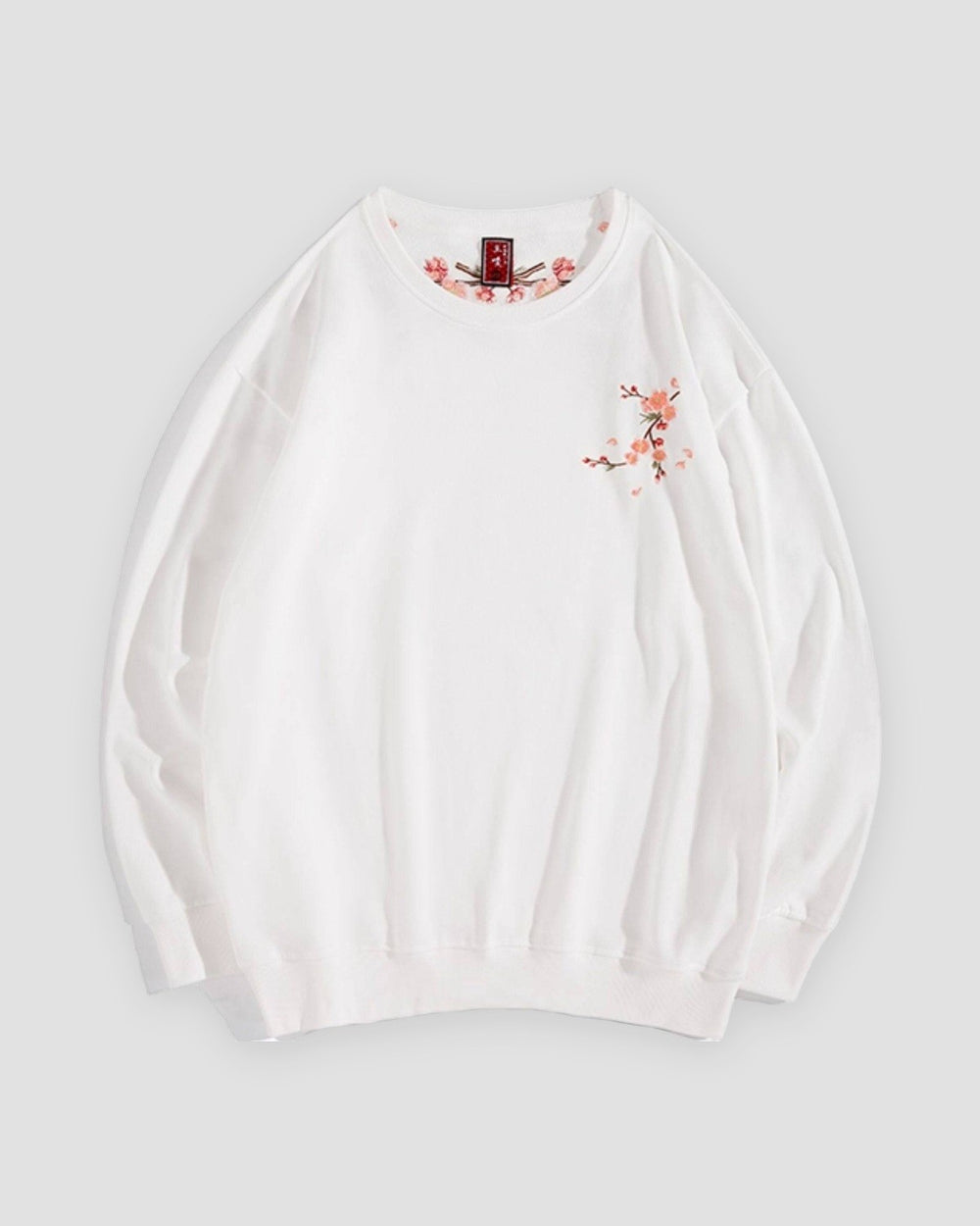 White crew-neck sweatshirt with a small embroidered blossom sprig on the chest, front view