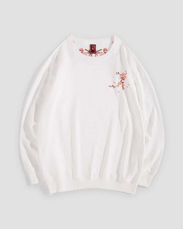 White crew-neck sweatshirt with a small embroidered blossom sprig on the chest, front view
