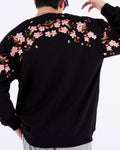 Black loose sweatshirt, back view with pink cherry-blossom branches embroidered across the shoulders