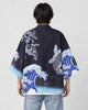 Man seen from behind in the black haori printed with a dragon, a carp and the Great Wave, over a white tee