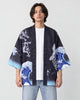 Man in the open black haori with a blue and white wave on the sleeves, white tee and jeans, front view