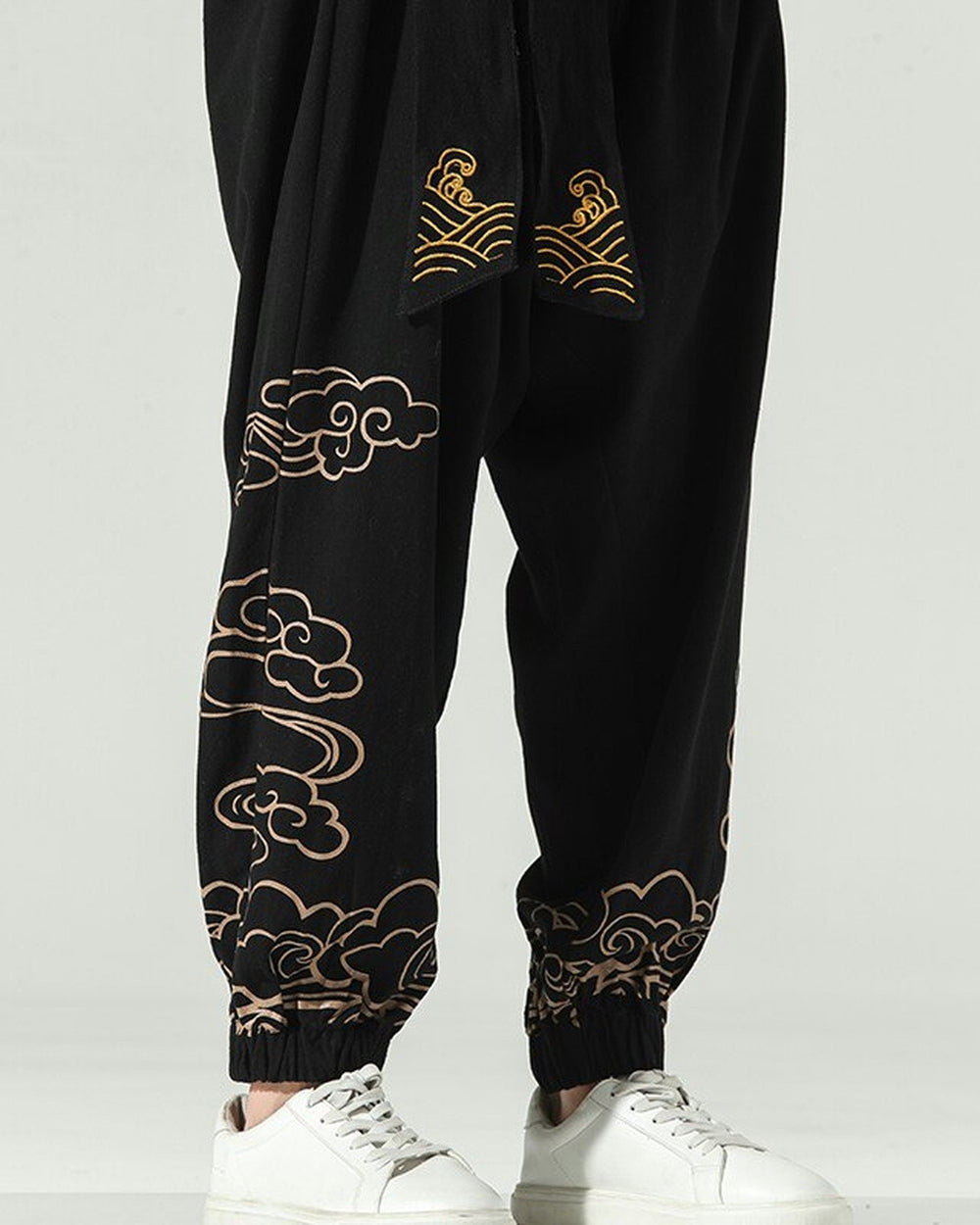 Close-up of the gold cloud embroidery down the lower leg and above the elastic cuff