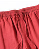 Close-up of the elastic waist and the drawcord on the red jogger pants