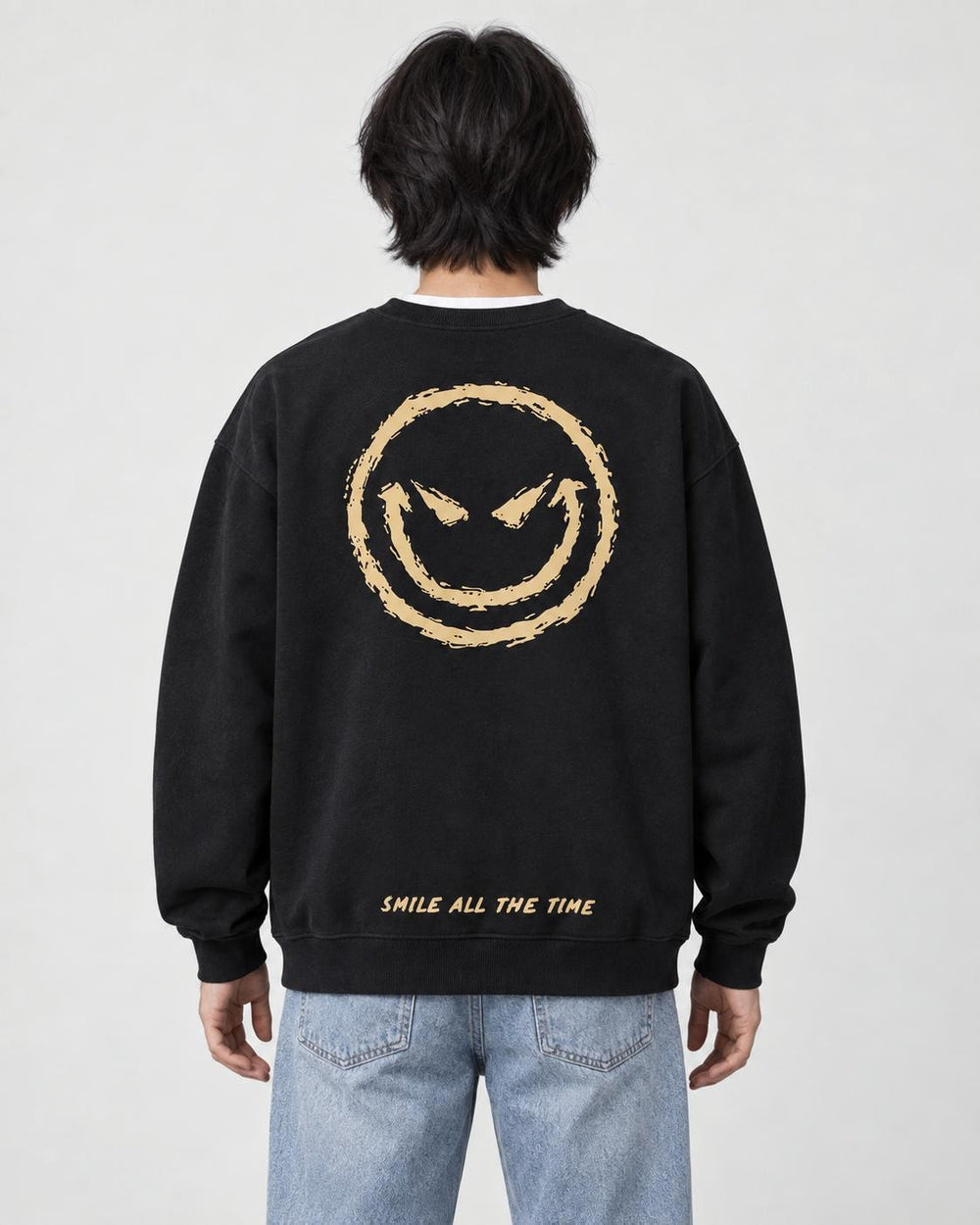 Model seen from behind in the black crewneck sweatshirt with a large gold devil smiley and SMILE ALL THE TIME at the hem