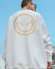 White crewneck sweatshirt seen from behind with a huge gold devil smiley and SMILE ALL THE TIME near the hem