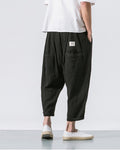 Back of the black crinkled harem pants showing the patch pocket with a small woven label