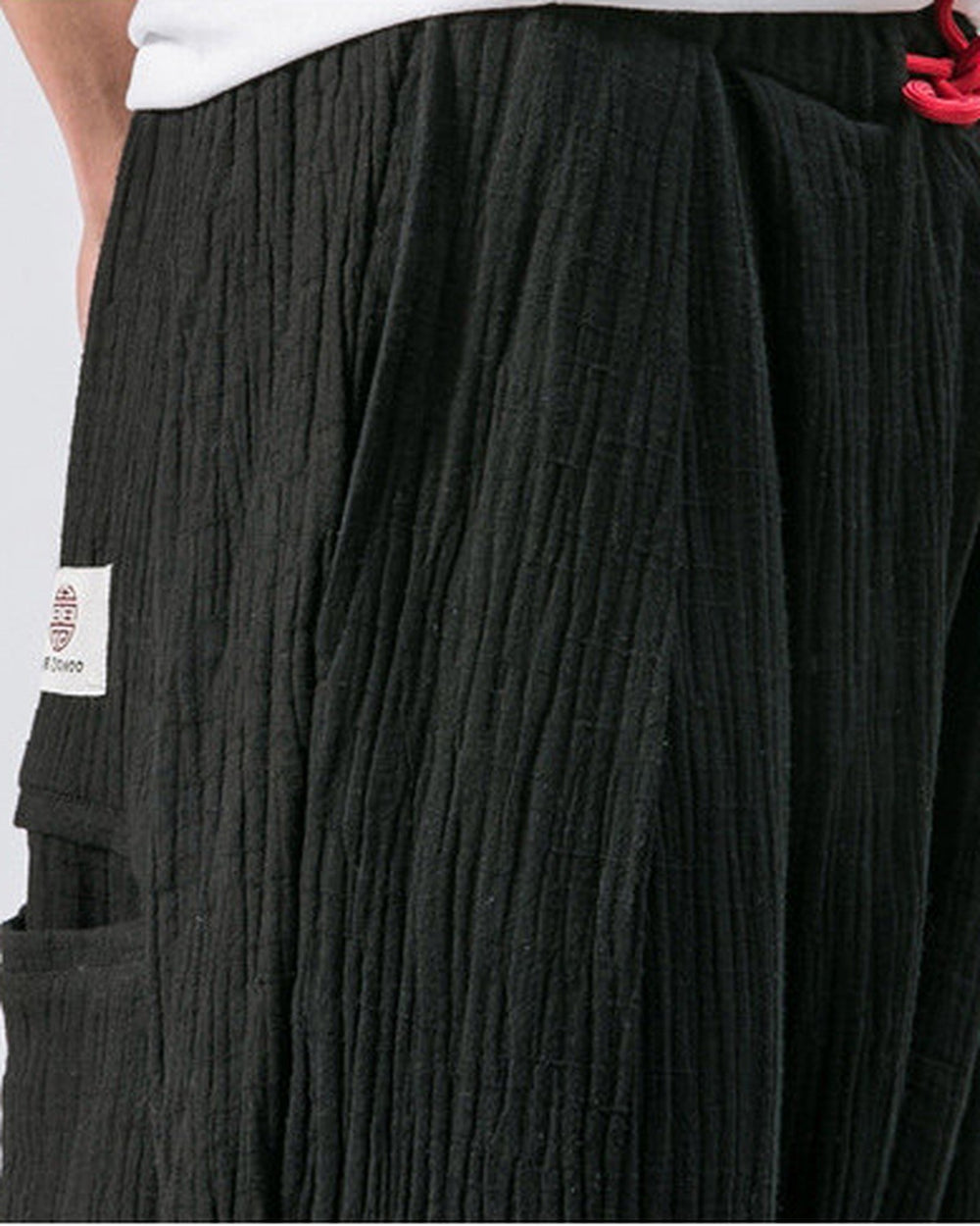 Close-up of the red drawcord and the crinkled weave on the black harem pants