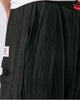 Close-up of the red drawcord and the crinkled weave on the black harem pants