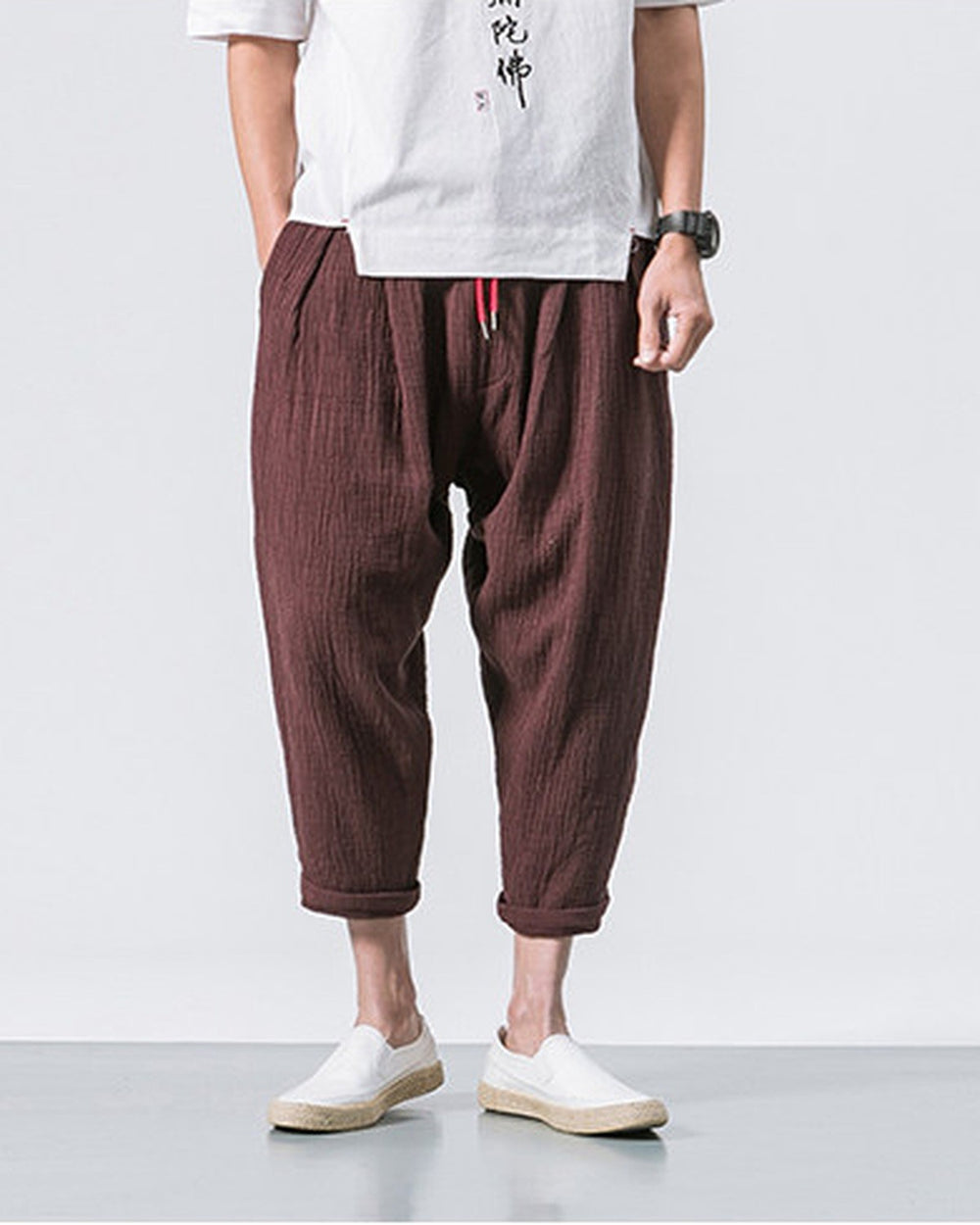 Coffee brown crinkled harem pants from the side, showing the tapered leg and the rolled cuff