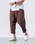Coffee brown crinkled harem pants in motion, showing the low crotch and the rolled cuffs