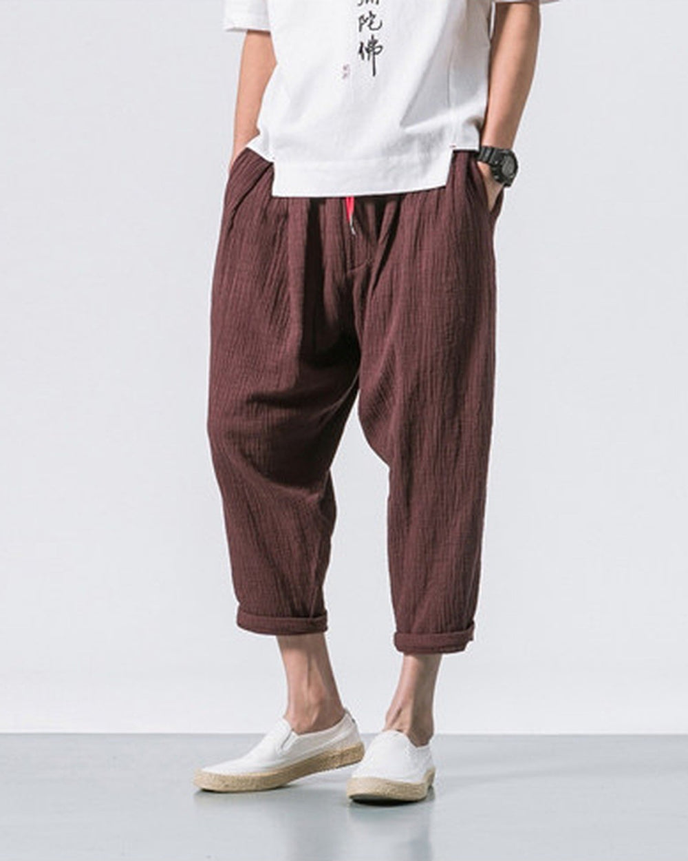 Coffee brown crinkled harem pants with a red drawcord and rolled cuffs, worn with a white tee and white slip-on shoes