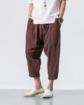 Coffee brown crinkled harem pants with a red drawcord and rolled cuffs, worn with a white tee and white slip-on shoes