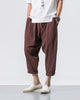 Coffee brown crinkled harem pants with a red drawcord and rolled cuffs, worn with a white tee and white slip-on shoes