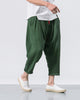 Forest green crinkled harem pants in motion, showing the low crotch and the rolled cuffs