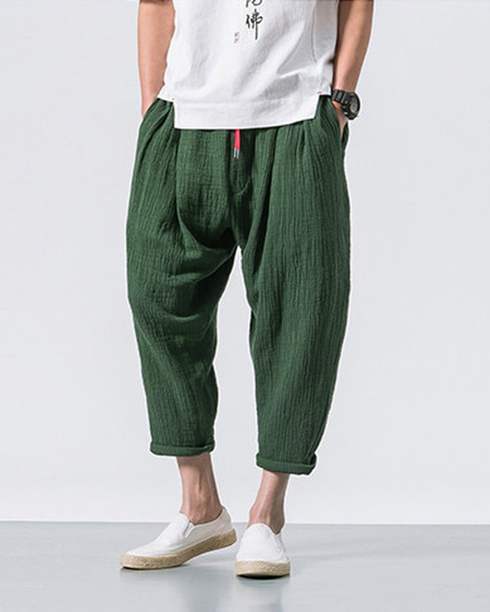 Forest green crinkled harem pants with a red drawcord and rolled cuffs, worn with a white tee and white slip-on shoes