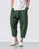 Forest green crinkled harem pants with a red drawcord and rolled cuffs, worn with a white tee and white slip-on shoes