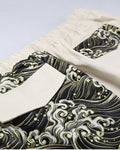 Close-up of the back flap pockets, one in cream cloth on the wave print and one in wave print on the cream