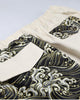 Close-up of the back flap pockets, one in cream cloth on the wave print and one in wave print on the cream