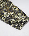 Close-up of the gathered elastic cuff on the wave-print leg