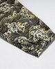 Close-up of the gathered elastic cuff on the wave-print leg