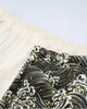 Close-up of the elastic waistband where the cream leg meets the wave-print leg