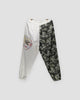 Cream and wave-print jogger pants with an embroidered dragon on the cream leg, front view