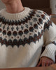 Close view of the round yoke in brown, charcoal and blue-gray on the cream sweater