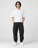 Model wearing the black cargo joggers with a white tee and white sneakers, front view