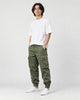 Model wearing the army green cargo joggers with a white tee and white sneakers, three-quarter view
