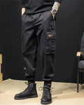 Black cargo joggers with a flap pocket and woven label, worn with black boots