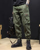 Army green cargo joggers with a flap pocket and woven label, worn with black boots