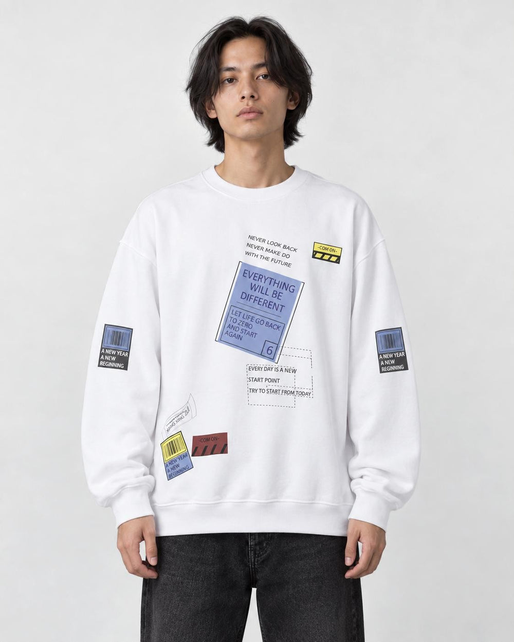 Model wearing the white label-print crewneck sweatshirt with black jeans, front view