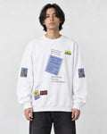 Model wearing the white label-print crewneck sweatshirt with black jeans, front view