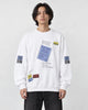 Model wearing the white label-print crewneck sweatshirt with black jeans, front view