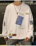 White crewneck sweatshirt, front view, with the blue label, a dotted text box and two small tags at the hem