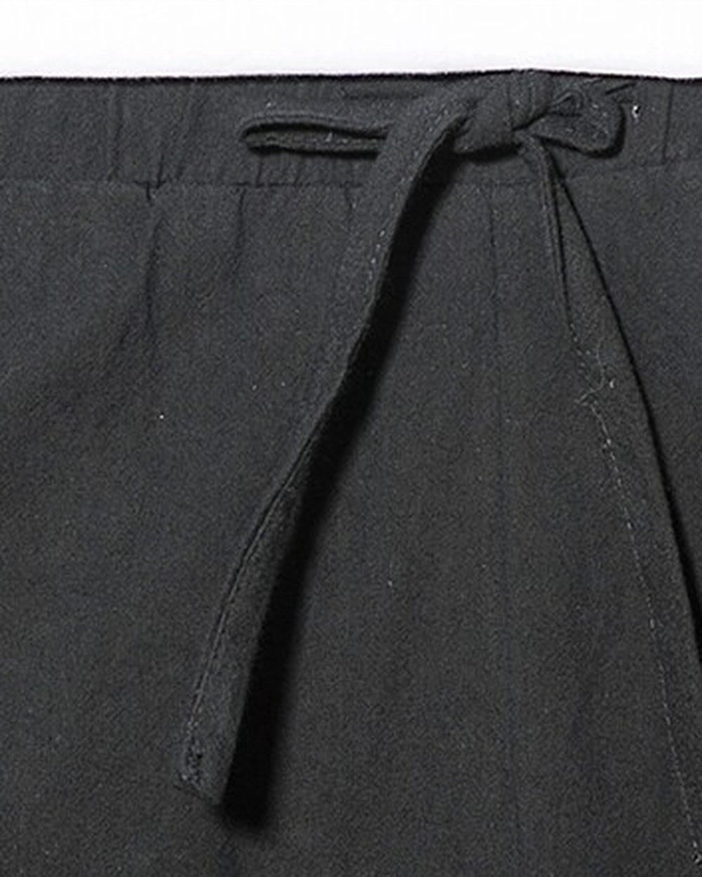 Close-up of the elastic waist and the flat drawcord on the black harem pants