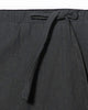 Close-up of the elastic waist and the flat drawcord on the black harem pants