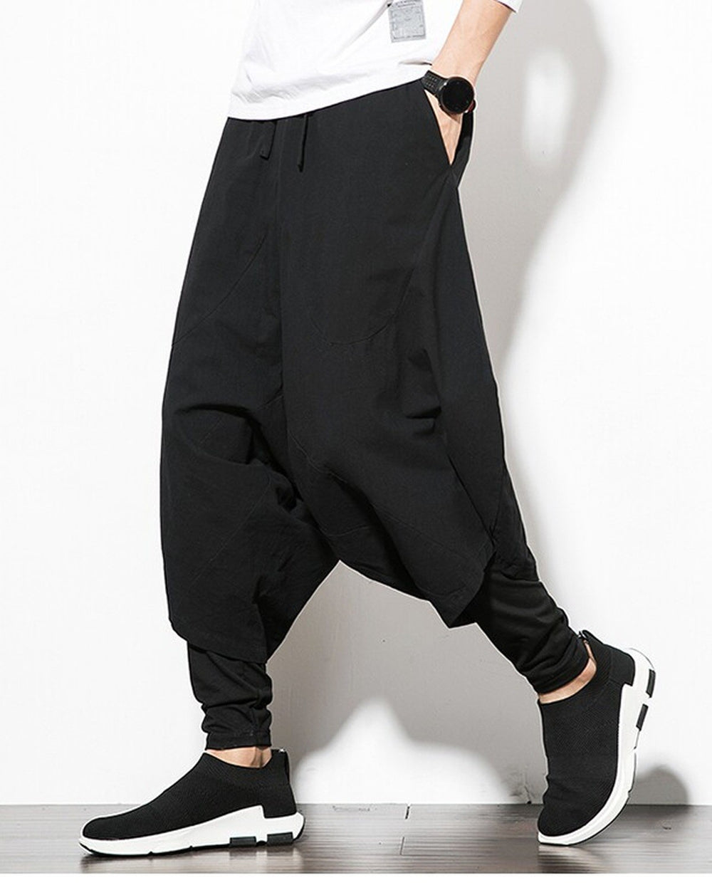 Black layered harem pants, side view, showing the baggy outer layer over the fitted inner layer